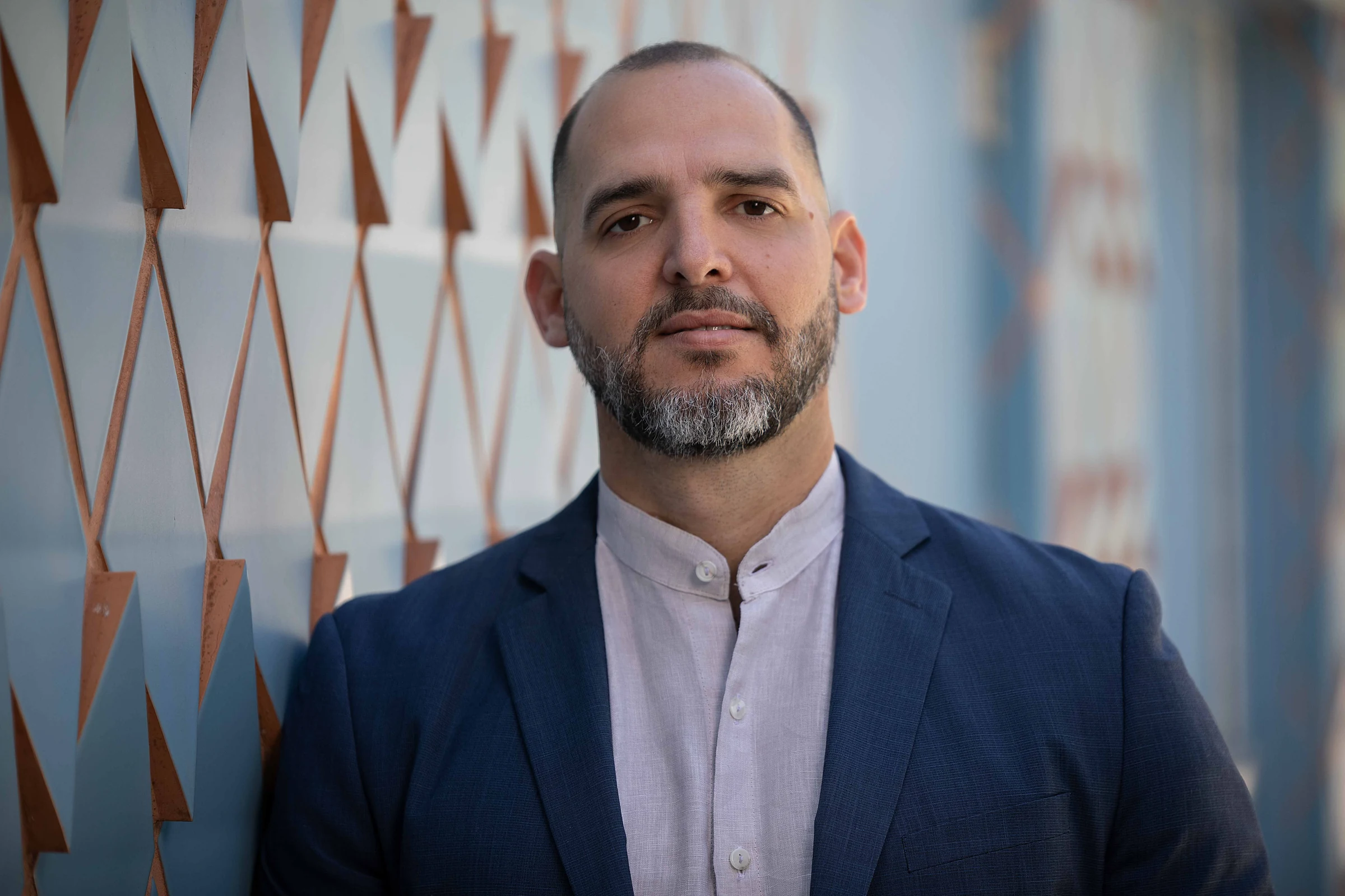 Jose Diaz in a navy jacket beside geometric Design District architecture.